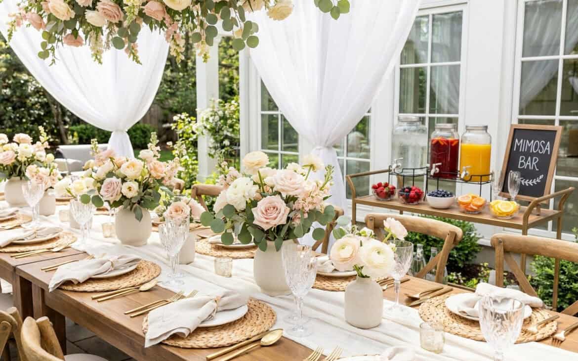 An elegant bridal shower brunch table with florals and a mimosa bar