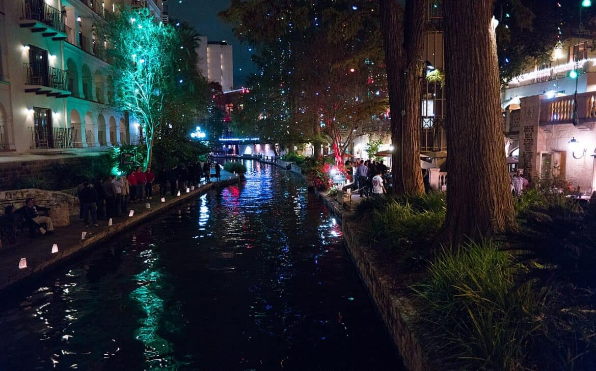 The San Antonio River Walk lit up with Christmas lights at night
