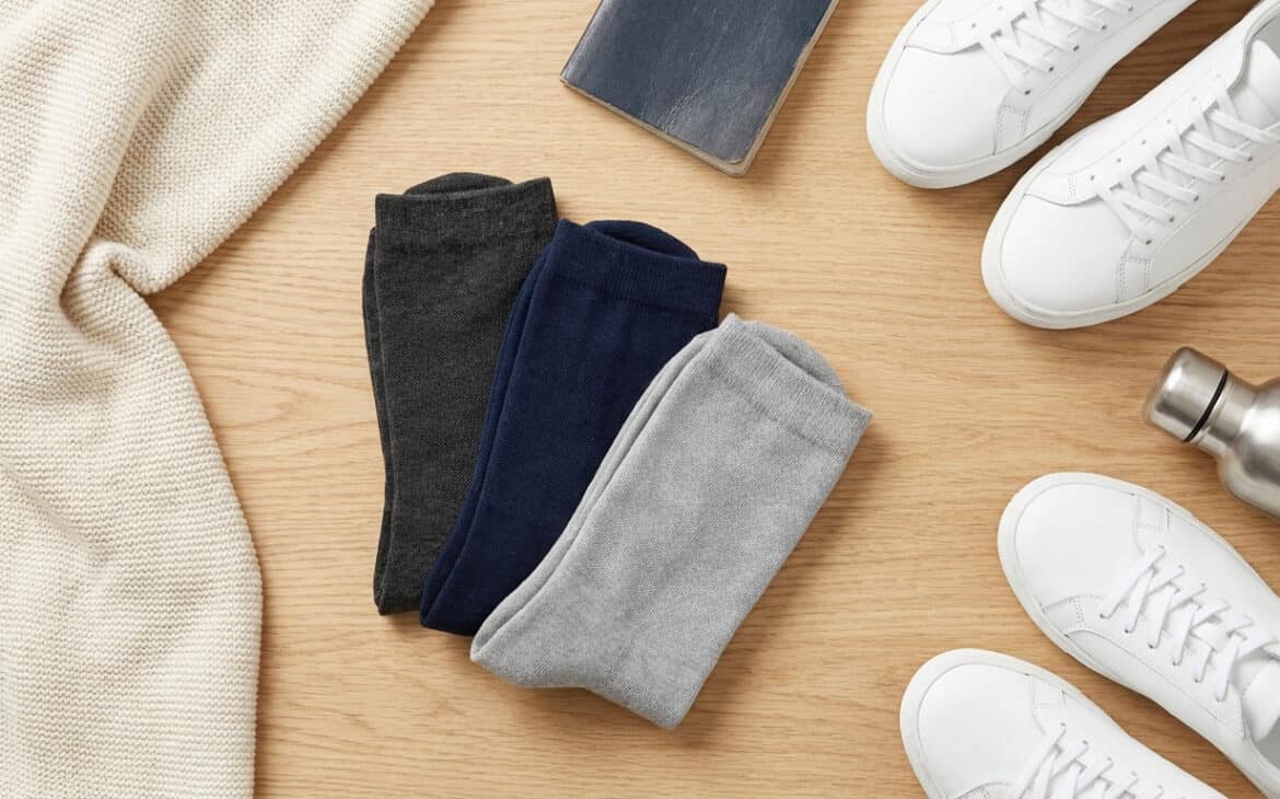 Folded compression socks beside travel essentials
